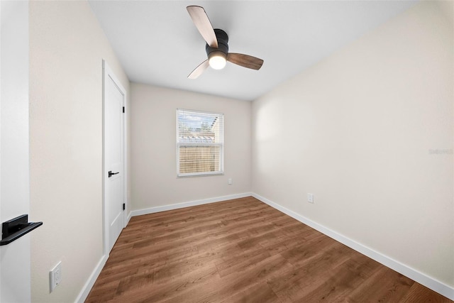 unfurnished bedroom with wood finished floors, a ceiling fan, and baseboards