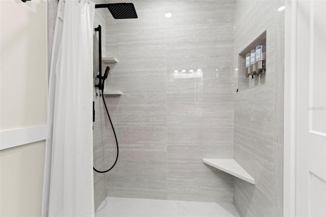 full bathroom with a tile shower