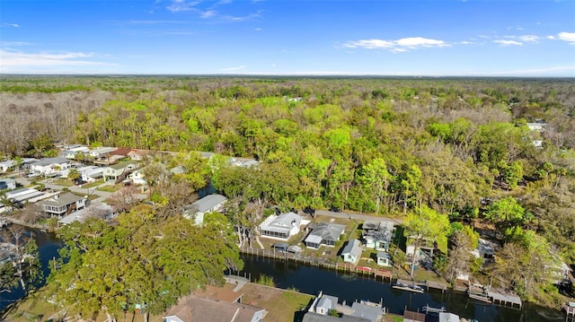 birds eye view of property featuring a water view, a forest view, and a residential view