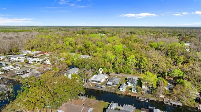 bird's eye view featuring a water view, a residential view, and a wooded view