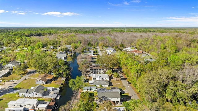 birds eye view of property with a water view, a residential view, and a wooded view