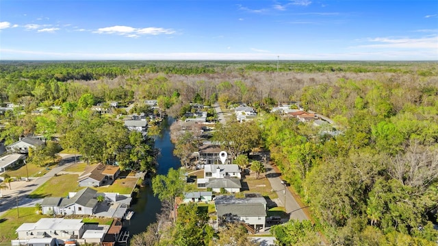 bird's eye view with a forest view, a water view, and a residential view