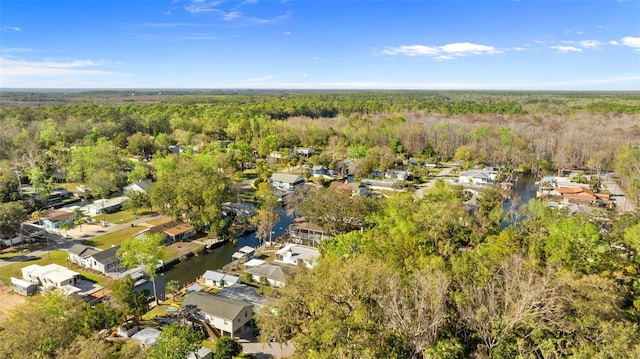 birds eye view of property featuring a water view, a forest view, and a residential view