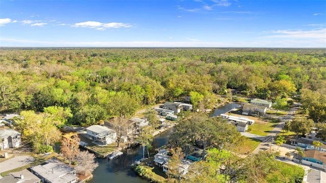 aerial view with a water view and a forest view