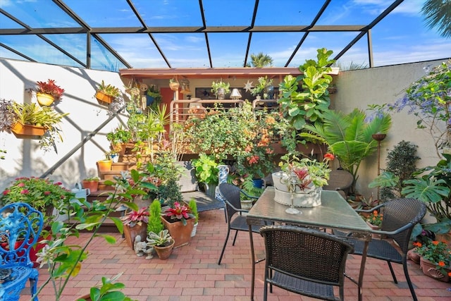 view of patio / terrace with glass enclosure and outdoor dining space