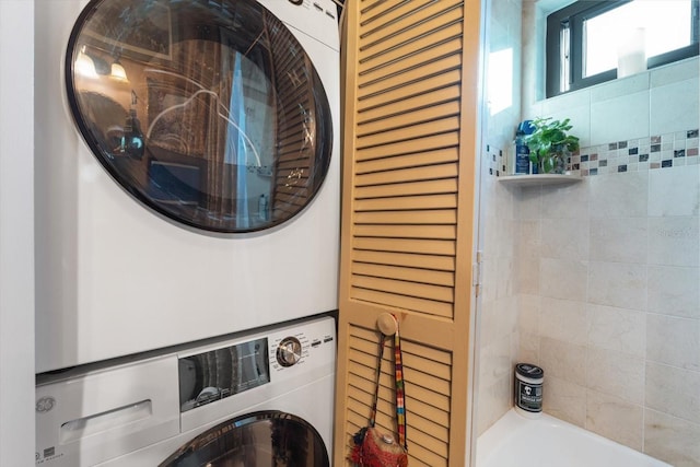 washroom with laundry area and stacked washer / drying machine