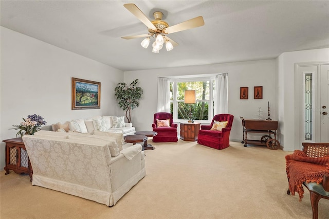 living area featuring ceiling fan and carpet flooring