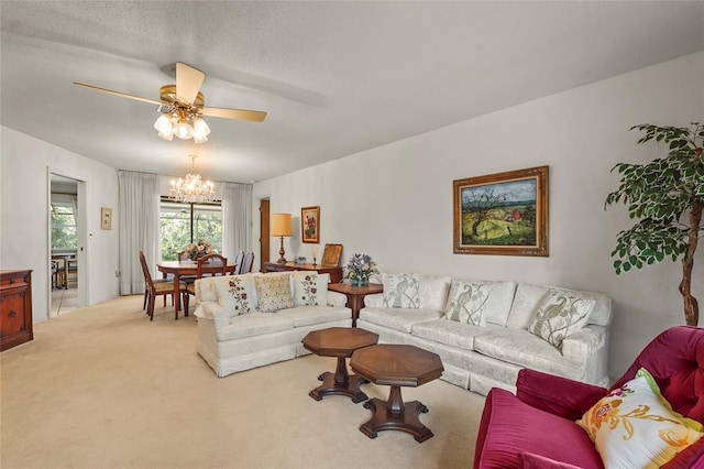 living area with ceiling fan with notable chandelier, a textured ceiling, and light colored carpet