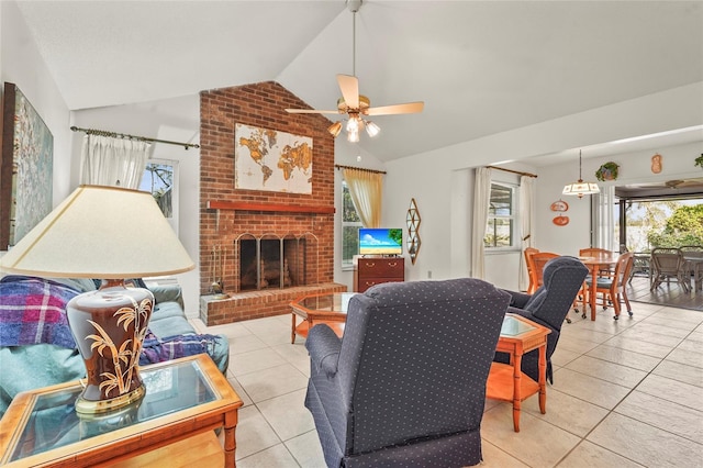 living area featuring lofted ceiling, plenty of natural light, a fireplace, and light tile patterned flooring