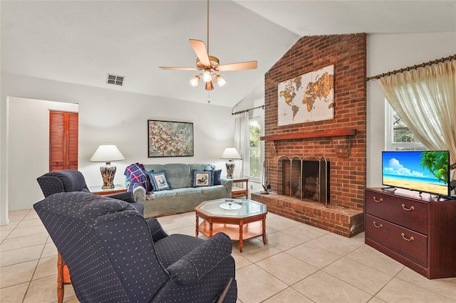 living room featuring lofted ceiling, light tile patterned flooring, a ceiling fan, visible vents, and a brick fireplace