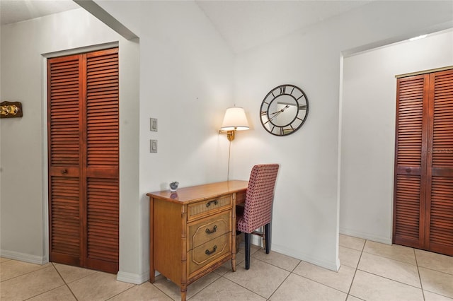 office space with baseboards and light tile patterned floors