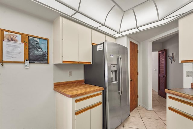 kitchen with stainless steel fridge with ice dispenser and light tile patterned floors