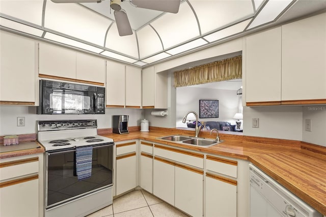 kitchen featuring range with electric cooktop, dishwasher, a ceiling fan, black microwave, and a sink