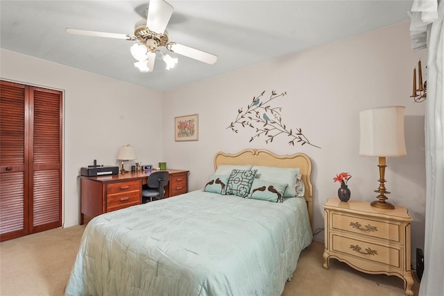 bedroom featuring light carpet, a closet, and a ceiling fan