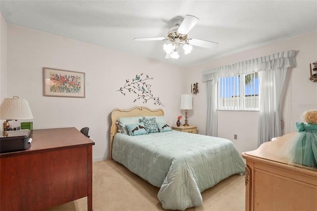 bedroom with a ceiling fan and light carpet