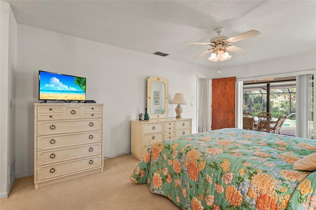 bedroom featuring access to exterior, light colored carpet, visible vents, and a ceiling fan