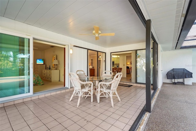 unfurnished sunroom with a ceiling fan