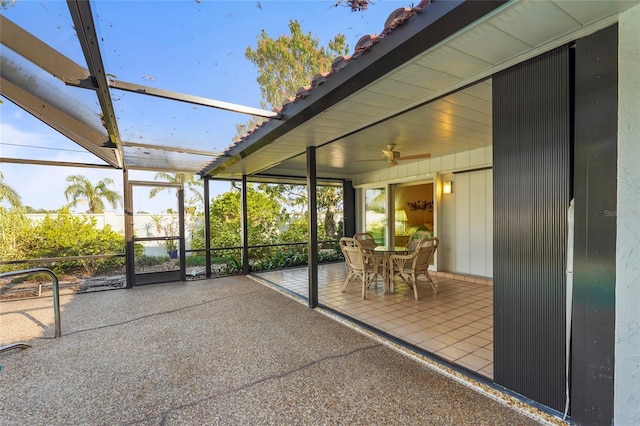 unfurnished sunroom featuring a ceiling fan