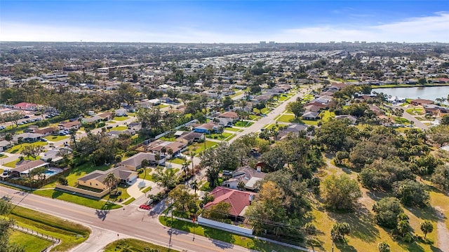 drone / aerial view with a water view and a residential view