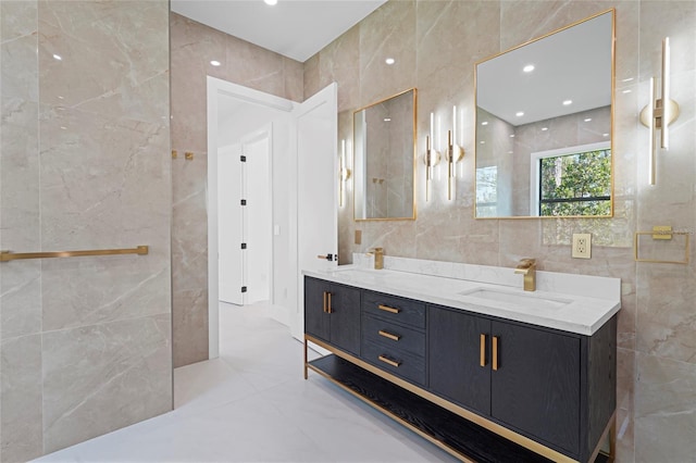 full bathroom with double vanity, a sink, tile walls, and recessed lighting