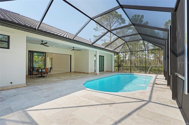 outdoor pool featuring a lanai, a patio area, and a ceiling fan