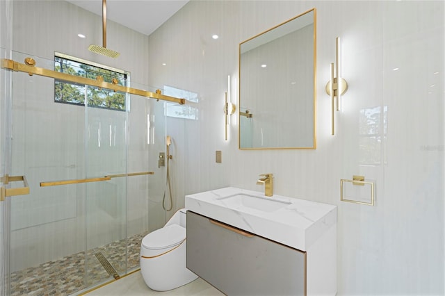 bathroom with toilet, a stall shower, and vanity