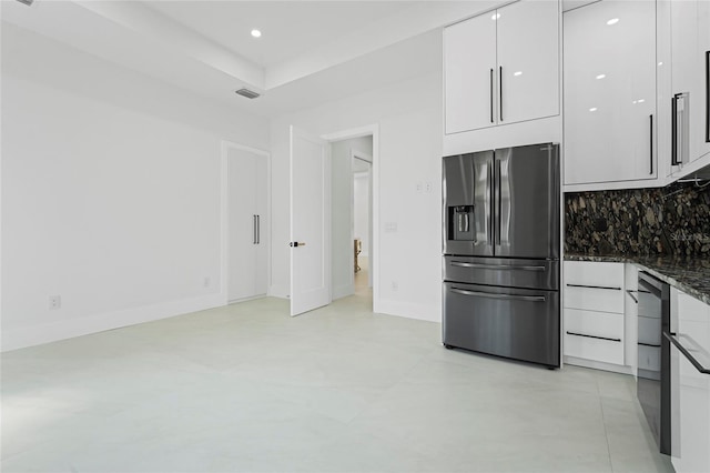 kitchen featuring tasteful backsplash, white cabinets, dark stone countertops, modern cabinets, and stainless steel fridge with ice dispenser