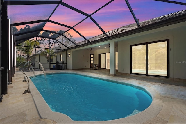 pool with a lanai, a patio area, and ceiling fan