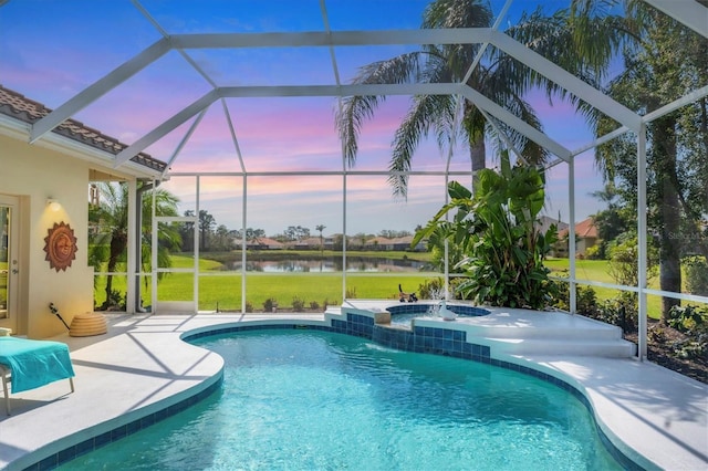 outdoor pool with a patio area, an in ground hot tub, a lanai, and a water view