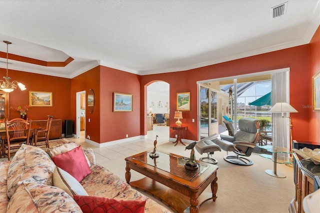 living room with arched walkways, light tile patterned floors, visible vents, ornamental molding, and baseboards