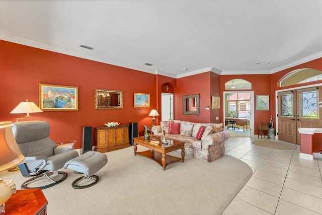 living room featuring light tile patterned flooring, visible vents, ornamental molding, and french doors