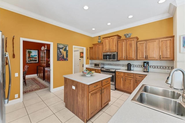 kitchen featuring a center island, stainless steel appliances, light countertops, backsplash, and a sink