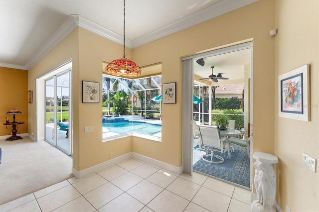 doorway featuring ornamental molding, tile patterned flooring, and a wealth of natural light