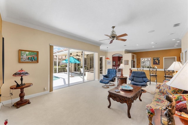 living room with carpet, visible vents, baseboards, and ornamental molding