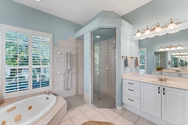 full bathroom featuring a whirlpool tub, a stall shower, tile patterned flooring, and vanity