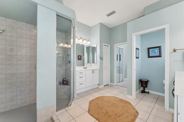 full bathroom with visible vents, vanity, a walk in shower, tile patterned flooring, and baseboards