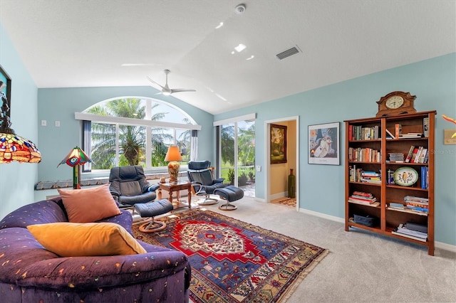 living area with baseboards, visible vents, a ceiling fan, vaulted ceiling, and carpet flooring