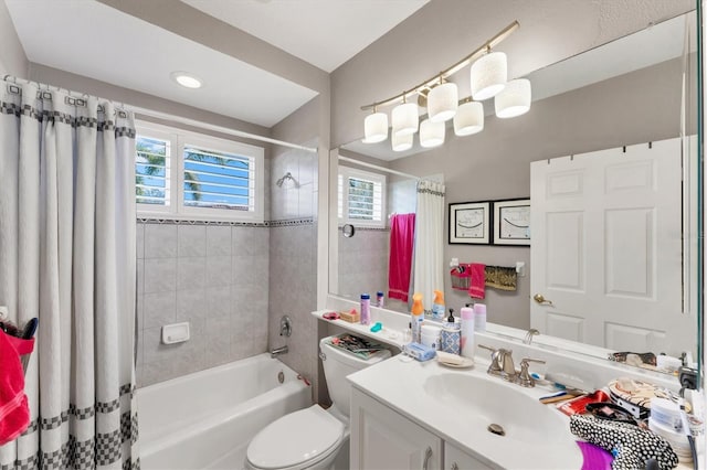 bathroom featuring shower / bath combination with curtain, vanity, and toilet