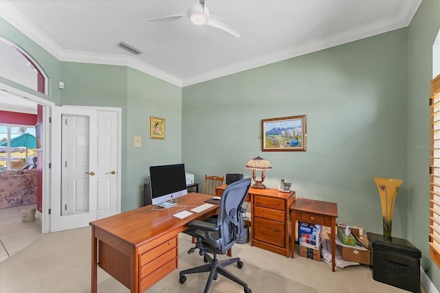 carpeted office space with a ceiling fan, visible vents, and crown molding