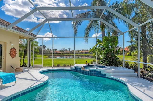 outdoor pool featuring an in ground hot tub, a patio area, a lanai, and a water view