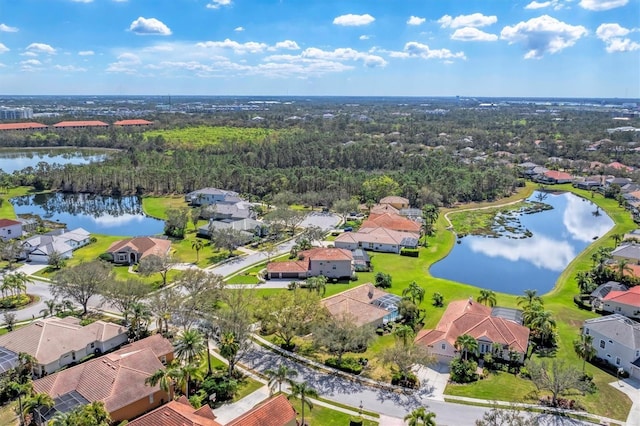 drone / aerial view featuring a water view and a residential view