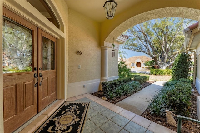 entrance to property with crawl space and stucco siding