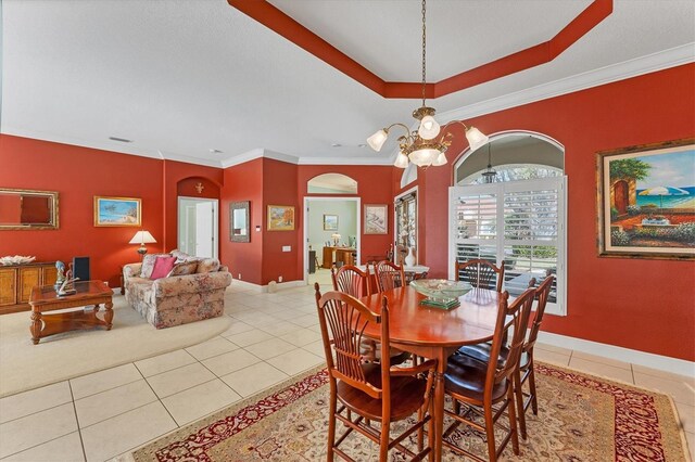 9612 Old Hyde Park Pl, Bradenton, FL 34202 - dining area with light tile patterned flooring, arched walkways, baseboards, and ornamental molding