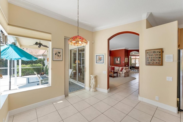 9612 Old Hyde Park Pl, Bradenton, FL 34202 - dining space featuring arched walkways, light tile patterned flooring, ceiling fan, ornamental molding, and baseboards