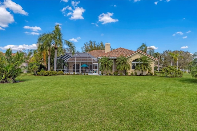 9612 Old Hyde Park Pl, Bradenton, FL 34202 - back of property with a yard, a chimney, glass enclosure, and a tiled roof