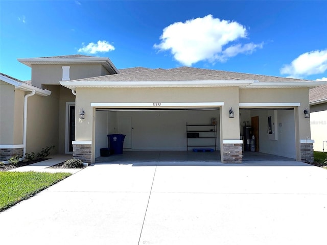 exterior space with stone siding, driveway, an attached garage, and stucco siding