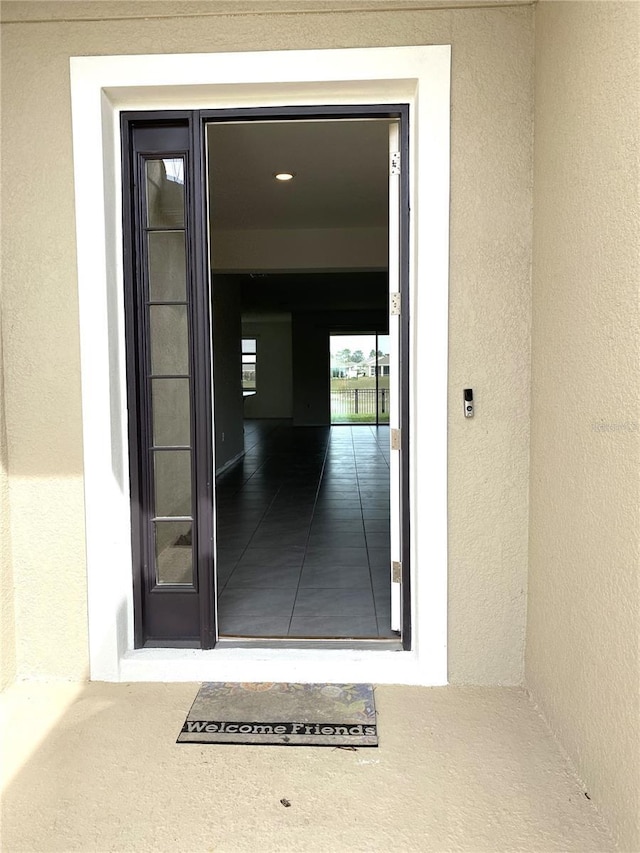 view of exterior entry featuring stucco siding