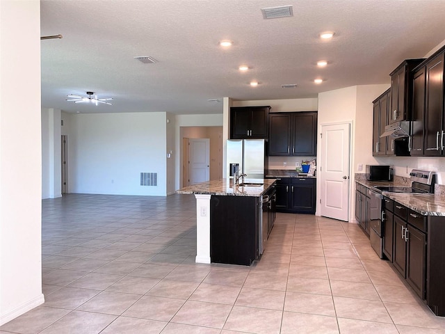 kitchen featuring open floor plan, stainless steel appliances, visible vents, and under cabinet range hood