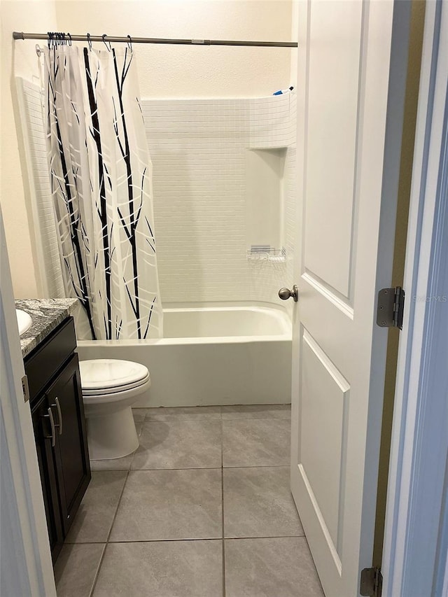 bathroom featuring vanity, shower / tub combo, tile patterned flooring, and toilet