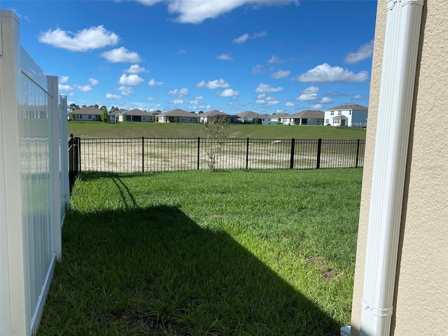 view of yard with a residential view and fence